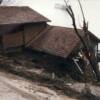 A home in the Magnolia area that was struck by a debris flow. Note damage where debris collapsed the front wall and flowed into the house.

USGS Image